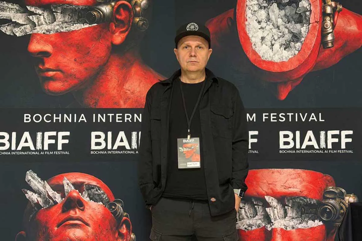 A guest standing in front of the BIAIFF festival wall