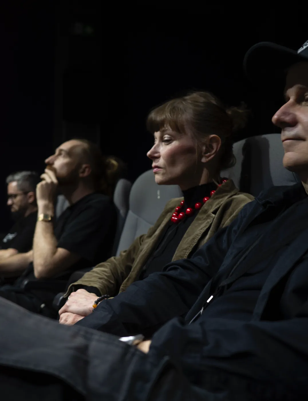 Guests watching the screening in the dark cinema hall